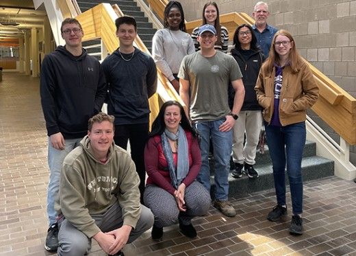 Math students and faculty on stair